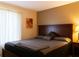 Comfortable bedroom with a large bed, a neutral color scheme, and soft, natural light streaming through the window at 1309 Pine Ridge E Cir # D3, Tarpon Springs, FL 34688