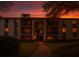 Beautiful multi-story condo building with balconies and landscaped lawn during a sunset at 1309 Pine Ridge E Cir # D3, Tarpon Springs, FL 34688
