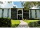 Multi-story condo building with balconies and landscaped lawn during a bright day at 1309 Pine Ridge E Cir # D3, Tarpon Springs, FL 34688