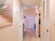 Hallway with tile flooring and louvered doors, providing access to various rooms in the home at 1309 Pine Ridge E Cir # D3, Tarpon Springs, FL 34688