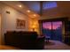 Cozy living room with a comfortable sofa and beautiful sunset view from the balcony at 1309 Pine Ridge E Cir # D3, Tarpon Springs, FL 34688