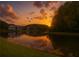 Scenic pond with trees and a building reflecting the sunset on the water at 1309 Pine Ridge E Cir # D3, Tarpon Springs, FL 34688