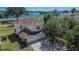 Aerial shot showcasing the home's exterior, three-car garage, and lush surrounding landscape at 13421 Sydney Rd, Valrico, FL 33594
