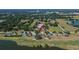 Aerial view of house in a suburban neighborhood next to a lake at 13421 Sydney Rd, Valrico, FL 33594