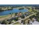 Aerial view of home on a golf course with lush green surroundings and lake at 13421 Sydney Rd, Valrico, FL 33594