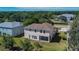 View of the back exterior, showcasing the lawn and screened in patio at 13421 Sydney Rd, Valrico, FL 33594