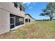 Grassy backyard and screened in porch ideal for enjoying the peaceful outdoors in this lovely residential area at 13421 Sydney Rd, Valrico, FL 33594