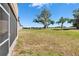 Expansive backyard space with verdant grass and mature trees offers plenty of room for outdoor activities at 13421 Sydney Rd, Valrico, FL 33594