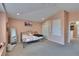 Bedroom with soft peach walls, comfortable carpet and closet at 13421 Sydney Rd, Valrico, FL 33594
