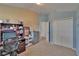 Bedroom featuring neutral and blue paint, and a closet with mirrored doors, plus desk and dresser at 13421 Sydney Rd, Valrico, FL 33594