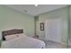 The bedroom features a full closet, soft carpet, and calming green walls, ideal for restful nights at 13421 Sydney Rd, Valrico, FL 33594