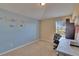 A cozy bedroom featuring blue accent wall with -like animal decals, desk, and natural light at 13421 Sydney Rd, Valrico, FL 33594