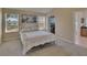 Bright bedroom with a window, beige walls, and comfortable bedspread at 13421 Sydney Rd, Valrico, FL 33594