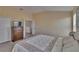 Bright bedroom with a dresser, soft peach walls, and comfortable bedspread at 13421 Sydney Rd, Valrico, FL 33594