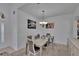 Elegant dining room featuring a chandelier, neutral walls, carpet flooring, and an adjacent living area at 13421 Sydney Rd, Valrico, FL 33594