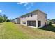 Back exterior featuring a well-kept lawn, ideal for outdoor entertaining and peaceful relaxation at 13421 Sydney Rd, Valrico, FL 33594