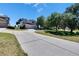 Exterior of home featuring a three-car garage, wide driveway, and a landscaped yard at 13421 Sydney Rd, Valrico, FL 33594