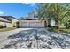 Spacious driveway leading to a two-story home with a well-maintained lawn and landscaping at 13421 Sydney Rd, Valrico, FL 33594