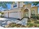 Charming two-story home with a welcoming entryway, a two car garage, and landscaped surroundings at 13421 Sydney Rd, Valrico, FL 33594