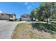 Charming home exterior featuring a well-manicured lawn and three-car garage at 13421 Sydney Rd, Valrico, FL 33594