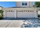 Front exterior view of a two car garage showcasing its doors and design elements at 13421 Sydney Rd, Valrico, FL 33594