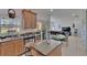 Kitchen view showcasing open layout with an island, dining space, and view of the backyard at 13421 Sydney Rd, Valrico, FL 33594