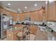 Functional kitchen area with stainless steel appliances and a central island for food prep and seating at 13421 Sydney Rd, Valrico, FL 33594