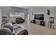Spacious living room featuring tile floors, neutral walls, a TV area, and a back door at 13421 Sydney Rd, Valrico, FL 33594