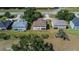 Aerial view of the back of a two-story house surrounded by trees and lawn at 13421 Sydney Rd, Valrico, FL 33594
