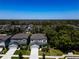 An aerial view of a well-maintained home, situated amongst lush trees and neatly landscaped yards at 14146 Samoa Hill Ct, Riverview, FL 33569