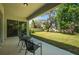 A covered patio with outdoor seating overlooks a spacious, well-maintained backyard at 14146 Samoa Hill Ct, Riverview, FL 33569