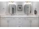 Bright bathroom with a double sink vanity featuring gold hardware and framed mirrors at 14146 Samoa Hill Ct, Riverview, FL 33569