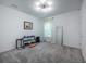 Minimalist bedroom with neutral tones, mirrored accent, and fitness equipment at 14146 Samoa Hill Ct, Riverview, FL 33569
