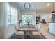 Cozy dining area with a modern chandelier, large window, and open access to the living room at 14146 Samoa Hill Ct, Riverview, FL 33569