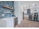 Kitchen area boasts floating shelves, a wine fridge, and an adjoining bar area at 14146 Samoa Hill Ct, Riverview, FL 33569