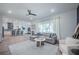 Bright, open-concept living room with modern furnishings and a view to the kitchen at 14146 Samoa Hill Ct, Riverview, FL 33569