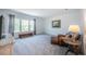 Bright living room with large windows, gray carpet, leather furniture, and neutral decor at 14146 Samoa Hill Ct, Riverview, FL 33569