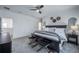 Main bedroom featuring a dark wood bed frame, neutral bedding, and carpet flooring at 14146 Samoa Hill Ct, Riverview, FL 33569