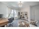 Sunlit office space featuring a large window, stylish decor, and comfortable seating at 14146 Samoa Hill Ct, Riverview, FL 33569