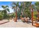 The backyard has a patio, multiple seating areas, and a variety of tropical plants at 15608 Starling Water Dr, Lithia, FL 33547