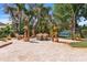 A backyard with a patio, fire pit, swing and well manicured landscaping at 15608 Starling Water Dr, Lithia, FL 33547