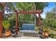 A backyard includes a swing, water features and pavers, surrounded by lush greenery at 15608 Starling Water Dr, Lithia, FL 33547