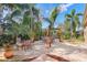 A backyard has a patio, fire pit, swing and plenty of room for entertaining at 15608 Starling Water Dr, Lithia, FL 33547