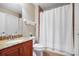 This bathroom features granite countertops, a toilet, and a shower with a white shower curtain at 15608 Starling Water Dr, Lithia, FL 33547