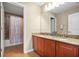 Bathroom featuring double vanity sinks, granite countertops, and tile flooring for a stylish design at 15608 Starling Water Dr, Lithia, FL 33547