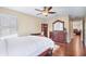 This bedroom features a ceiling fan, hardwood floors, and a dresser with mirror at 15608 Starling Water Dr, Lithia, FL 33547