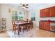 Bright dining room features a ceiling fan, a large window and a wooden table for a comfortable dining experience at 15608 Starling Water Dr, Lithia, FL 33547