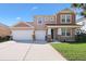 A two-story home has a three car garage, stone accents, and a well-manicured lawn at 15608 Starling Water Dr, Lithia, FL 33547