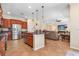 Spacious kitchen with granite counters, island seating, and open layout connecting to the dining and living spaces at 15608 Starling Water Dr, Lithia, FL 33547