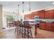 Kitchen with dark wood cabinetry, granite countertops, and a central island, open to a dining area at 15608 Starling Water Dr, Lithia, FL 33547